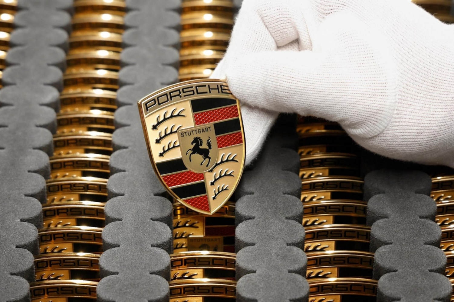 Hand holding porshe badge