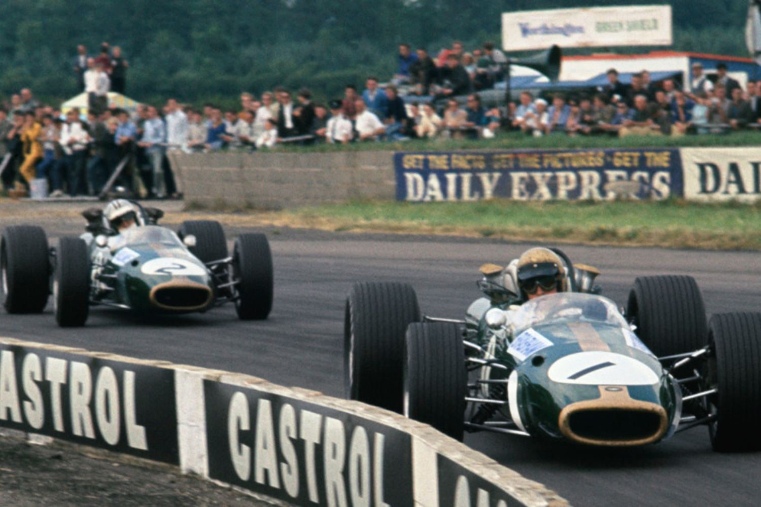 Brabham leads team-mate Denny Hulme, both driving Brabham BT24s, at the 1967 British Grand Prix.